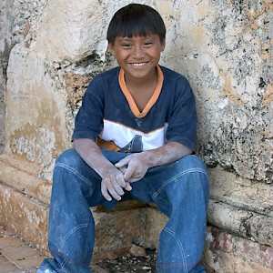 A young resident of Chunchucmil has just finished laying chalk lines for the campo de futbol (soccer field) and is taking a brief rest before the big game. <a href=></a>