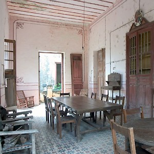 The comedor or diningroom at Hacienda Uayalceh still has furniture left behind when it was abandoned after the Revolution. A caretaker continues to live at the hacienda, but does not eat here. <a href=></a>